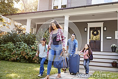 Family With Luggage Leaving House For Vacation Stock Photo