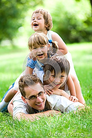 Family lying on grass Stock Photo