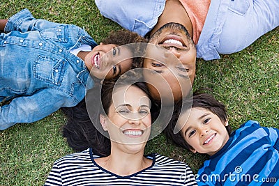 Family lying on grass Stock Photo