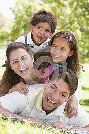 Family lying outdoors smiling Stock Photo
