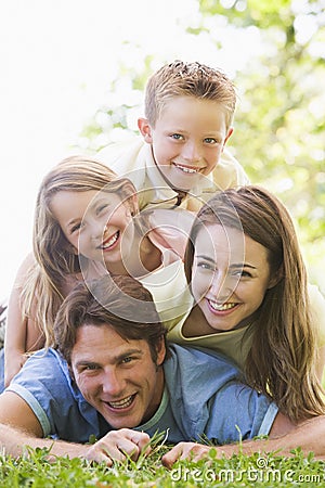 Family lying outdoors smiling Stock Photo