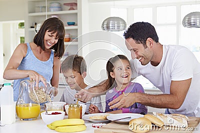 Family Making Breakfast In Kitchen Together Stock Photo