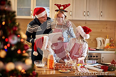 Family making Christmas cookies at home Stock Photo