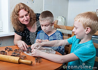 Family making gingerbread cookies Stock Photo