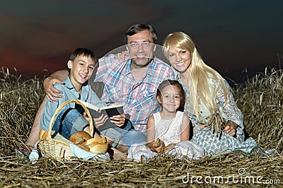 Family in the meadow at night Stock Photo