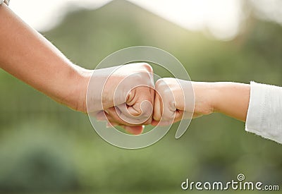 Family means nobody gets left behind or forgotten. a unrecognizable mother and son fist bumping outside. Stock Photo