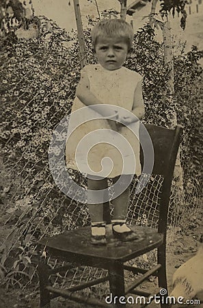 Family Memories: Little Girl on a Chair Editorial Stock Photo