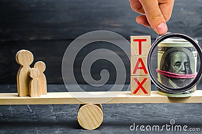 Family, money and the words `Tax ` on the scales. Taxes on real estate, payment. Penalty, arrears. Register of taxpayers for prope Stock Photo