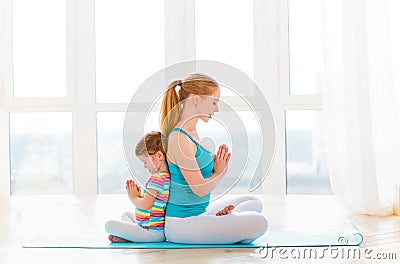 Family mother and child daughter are engaged in meditation and y Stock Photo