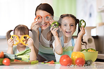 Family - mom and her children having fun in the kitchen Stock Photo