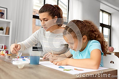 mother with little daughter drawing at home Stock Photo