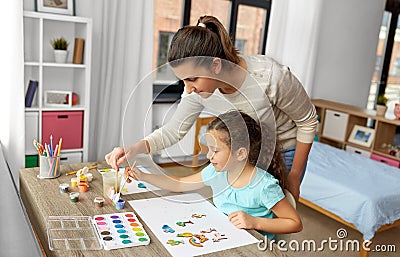 mother with little daughter drawing at home Stock Photo