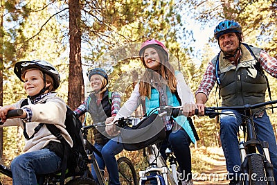 Family mountain biking in a forest, low angle front view Stock Photo