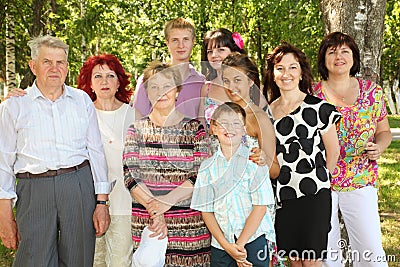 Family of nine people pose at park Stock Photo