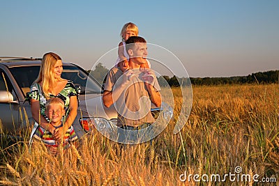 Family with offroad car on wheaten field Stock Photo