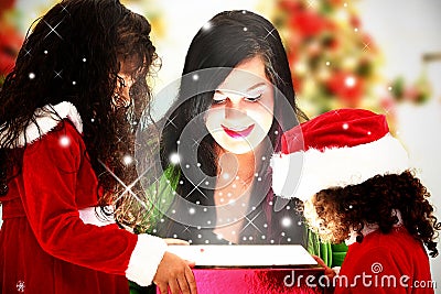 Family Opening Magical Christmas Present Stock Photo