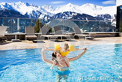 Family in outdoor swimming pool of alpine spa resort Stock Photo