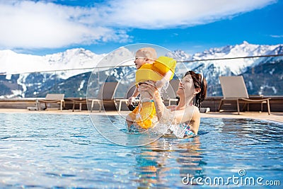 Family in outdoor swimming pool of alpine spa resort Stock Photo