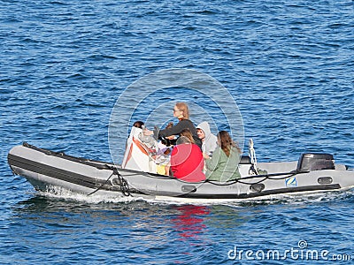 Family outing in an inflatable boat in front of Pendennis Castle near Falmouth Editorial Stock Photo