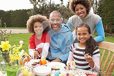 Family Painting Easter Eggs In Gardens Stock Photo