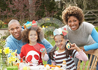 Family Painting Easter Eggs In Gardens Stock Photo