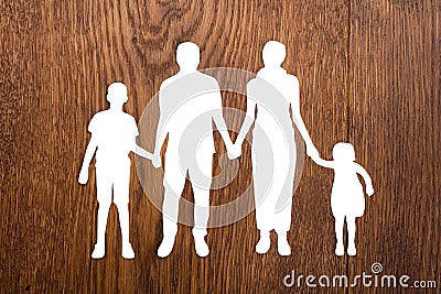 Family Papercut On Wooden Desk Stock Photo