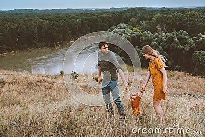 Family parents walking with baby daughter outdoor mother and father with child Stock Photo