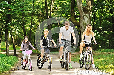 Family in the park on bicycles Stock Photo