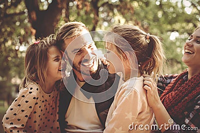 Family in park having conversation and hugging. Stock Photo