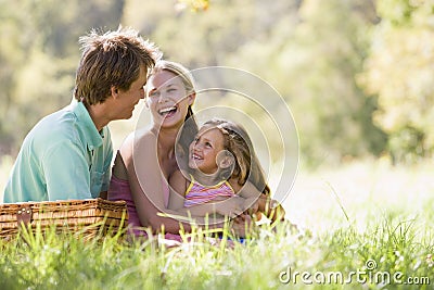 Family at park having a picnic and laughing Stock Photo