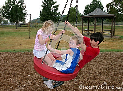 Family on Park Swing Playing Stock Photo