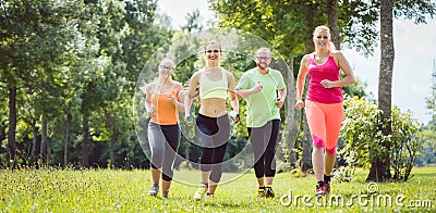 Family with personal Fitness Trainer jogging Stock Photo