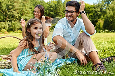 Family On Picnic. Happy Young Family Having Fun In Nature Stock Photo