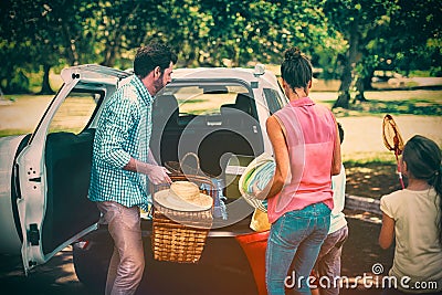 Family placing picnic items in car trunk Stock Photo