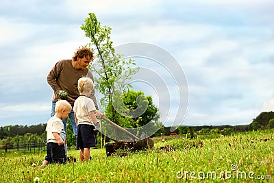 Family Planting Tree Stock Photo