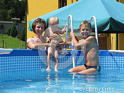 Family play in collapsible pool Stock Photo