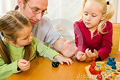 Family playing a board game Stock Photo