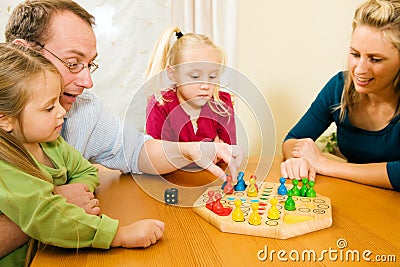 Family playing a board game Stock Photo