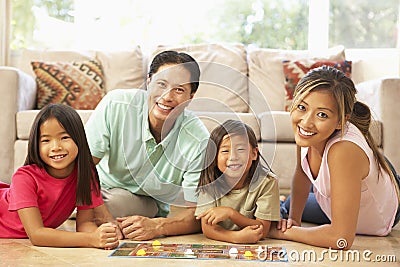Family Playing Board Game At Home Stock Photo