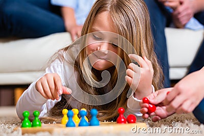 Family playing board game at home Stock Photo