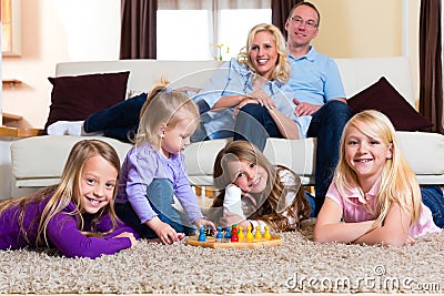Family playing board game at home Stock Photo