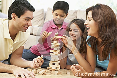 Family Playing Game Together At Home Stock Photo