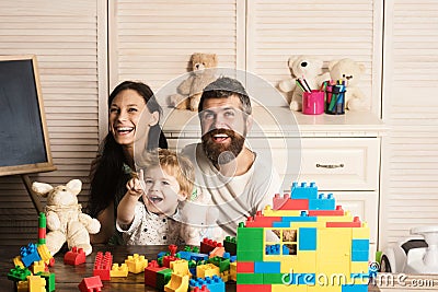 Family playing with plastic blocks and plush toys. Stock Photo