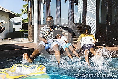 Family playing by a pool Stock Photo