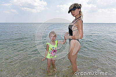 A family plays on the sand, the shore of the Black Sea. Stock Photo