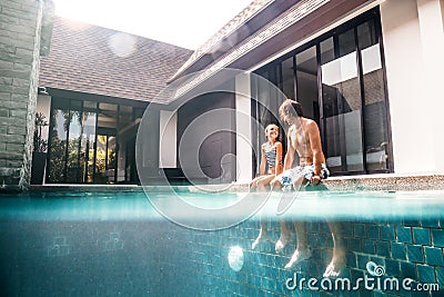 Family in the pool, split underwater Stock Photo