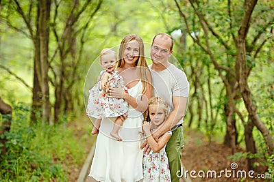 Family portrait - mother, father and two daughters blonde walkin Stock Photo