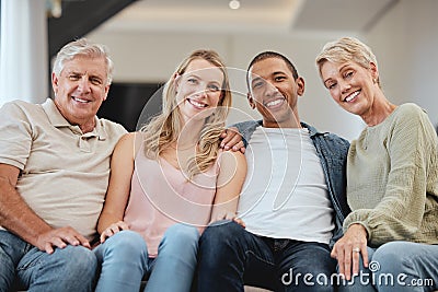 Family, portrait and relax in living room home, bonding and having fun. Interracial love, diversity and care of happy Stock Photo