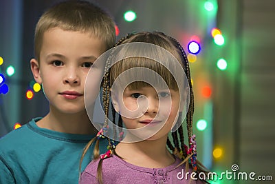 Family portrait of two young happy cute blond children, handsome boy and girl with lot of long braids, brother and sister smiling Stock Photo