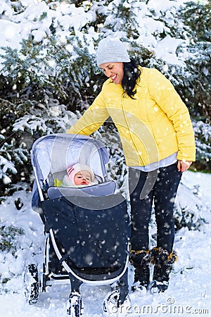 Family portrait in the winter forest, mother and baby, bright snowy fir trees, beautiful nature Stock Photo